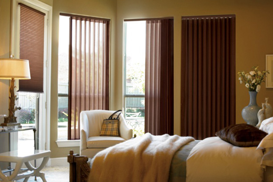 Choose durable and high-quality fabric or vinyl vertical blinds in Charlotte. Maroon fabric vertical blinds inside a bedroom