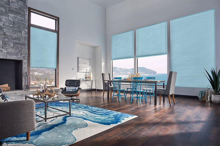 Smart motorized window shades are perfect on tall windows in your Charlotte home. Blue motorized shades on tall living room windows