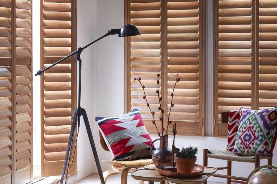 Brown wood shutters on a living room door and window