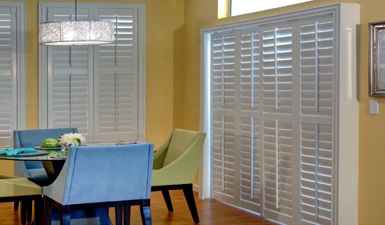 Plantation shutters on a French door work like common window shutters. Patio Doors with Plantation Shutters in Charlotte